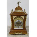 A large gilt metal mounted oak mantel clock, the brass and steel dial inscribed 'W Roberts
