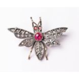 A yellow metal multi gemstone set insect brooch formed as a bee, length 3.4cm, gross wt. 5.5g.