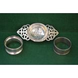 Two handled tea strainer, marked for Birmingham 1920 and two napkin rings,