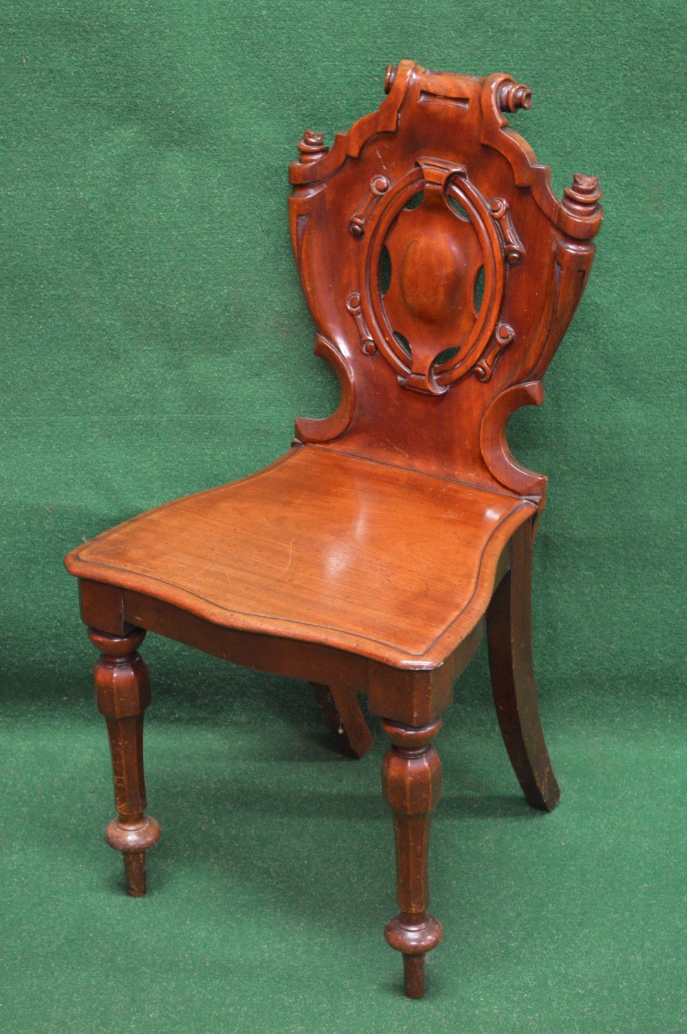 Victorian mahogany hall chair having shield shaped back with central pierced decoration and