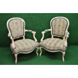 Pair of painted open armchairs having shaped padded backs and arms over a shaped padded seat,