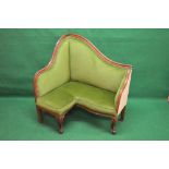 Mahogany show wood framed corner seat having arched back and shaped arms with green padded