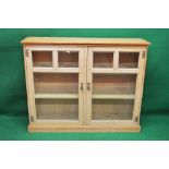 Victorian pine glazed bookcase each door having three bevelled glass panels enclosing two