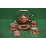 Victorian copper kettle together with a group of six copper jelly moulds