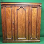 Victorian mahogany triple wardrobe having moulded cornice over three shaped panelled doors,