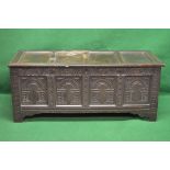 Oak carved four panel coffer the lid opening to reveal storage space and having carved decorated