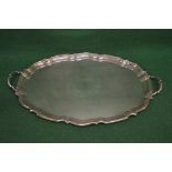 Oval silver serving tray having shaped gadrooned border and two side carrying handles,