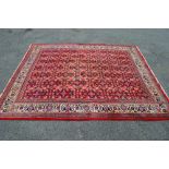 Red ground Persian Sarouk Mahal carpet having central panel decorated with blue,
