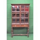 Oak glazed bookcase having moulded cornice over two glazed doors opening to reveal three adjustable