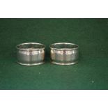 Pair of circular napkin rings with engine turned decoration,