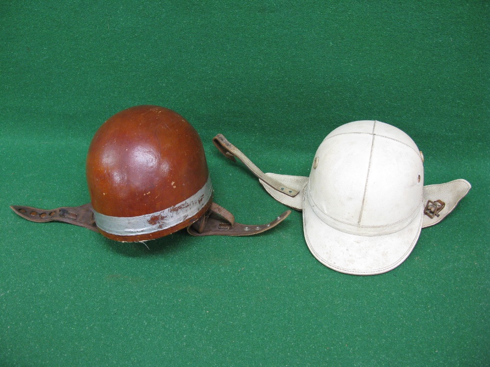 Two vintage cork motorcycle helmets to comprise: a peaked Corker by J Compton Sons & Webb Ltd and a