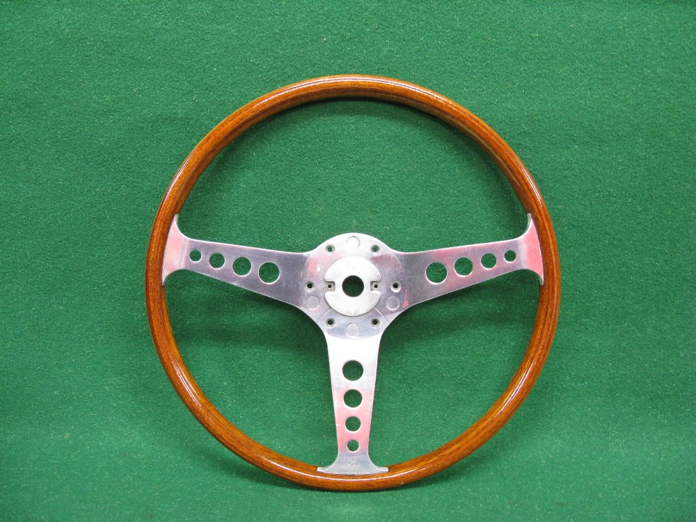 Slightly dished wooden rimmed polished alloy steering wheel stamped LL Walsall Wheels Ltd,