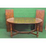 Mid to late 20th century oak extending dining table having rounded ends supported on turned