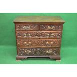 19th century oak chest of drawers the top having moulded edge over two carved drawers and three