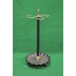 Brass and iron stick stand having brass hoop carrying handle over three scrolled stick supports on