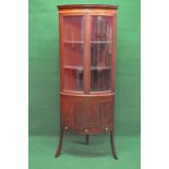 Edwardian mahogany free standing corner cupboard having two glazed doors opening to reveal two