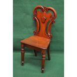 Victorian mahogany hall chair having pierced and scrolled decorated back over solid seat,