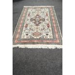 Cream ground rug with red and pink pattern and end tassels - 110" x 68"