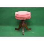 Circular revolving piano stool having upholstered padded seat supported on a turned column leading