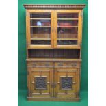 Oak glazed bookcase having two glazed upper doors enclosing three adjustable shelves over open