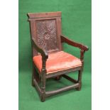 Oak open elbow hall chair having carved panelled back over later added upholstered seat,