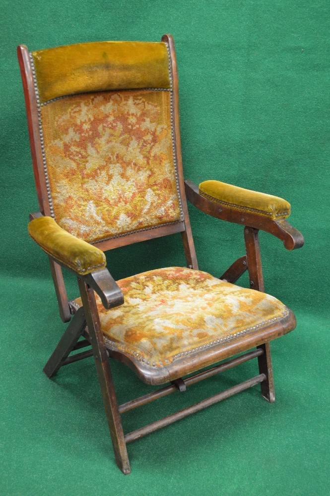 Edwardian folding campaign chair having padded head rest over upholstered back with padded arms and