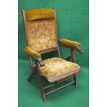 Edwardian folding campaign chair having padded head rest over upholstered back with padded arms and