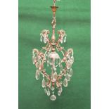 Brass and glass chandelier having facet cut drops