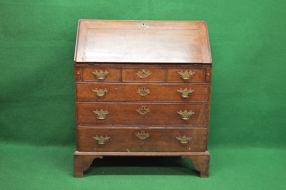 Georgian oak bureau having fall front opening to reveal drop well and fitted interior of drawers