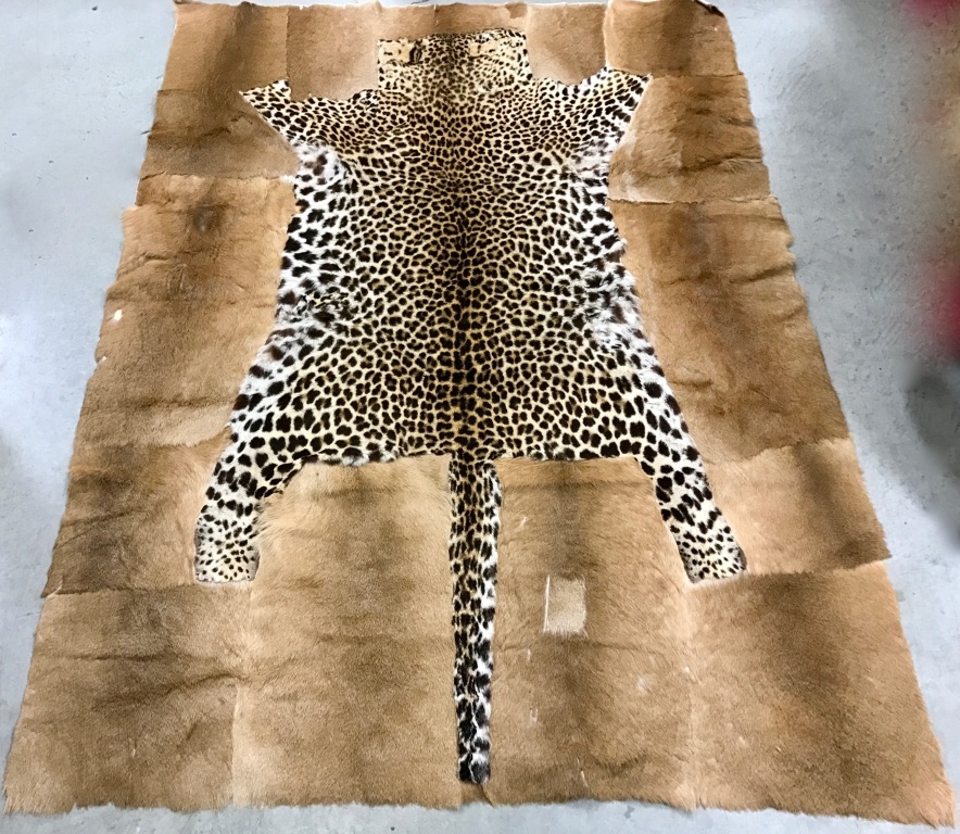 An African Kaross rug, with a leopard skin insert 197cm long & 188cm wide