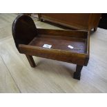 A small wooden dolls bed