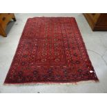 A 20th century decorative carpet, with repeated boarder on red ground