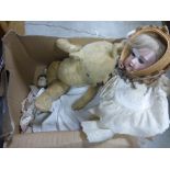 A vintage teddy bear, along with three dolls