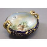 A 20th century two handled bowl decorated with cherubs and female winged figures