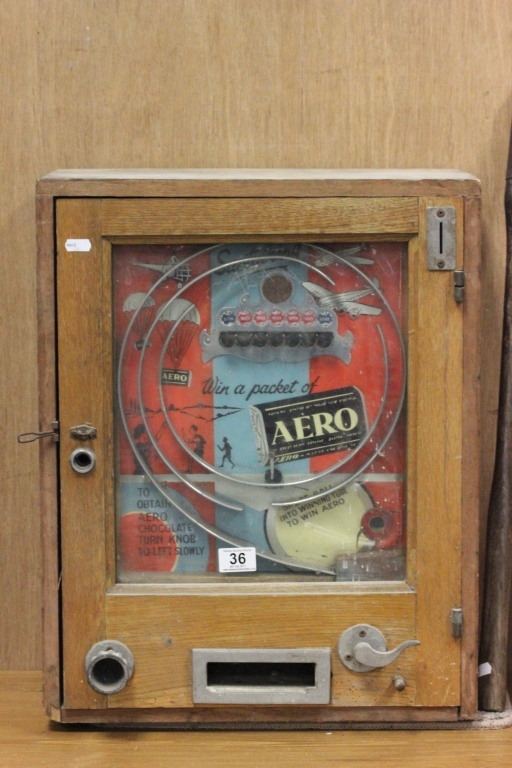A vintage vending machine game, "Win a packet of Aero" in an oak frame