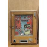 A vintage vending machine game, "Win a packet of Aero" in an oak frame