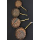 Four Small Copper Graduating Frying Pans with Brass Handles