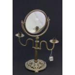 A brass free standing mirror and candlestick