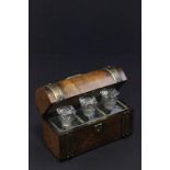 A Victorian walnut fitted dome topped pharmaceutical travelling case with three small glass jars and