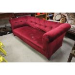 A chesterfield sofa, on turned mahogany legs