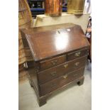 Small Georgian Oak Drop Front Bureau with Two over Two Drawers and raised on bracket feet