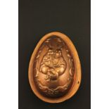 A early 20th century copper two piece chocolate mould decorated in relief of easter bunnies marked