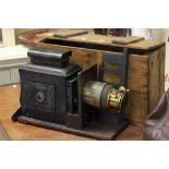 Vintage brass and tin plate slide projector in pine box