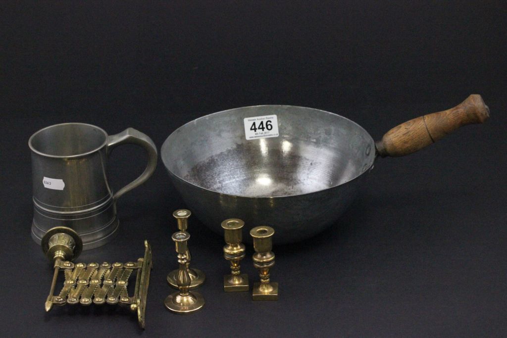 A brass extending wall candlestick, metal scoop with wooden handle and pewter tankard