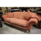 Two Seater Sofa raised on four wooden legs and brass castors