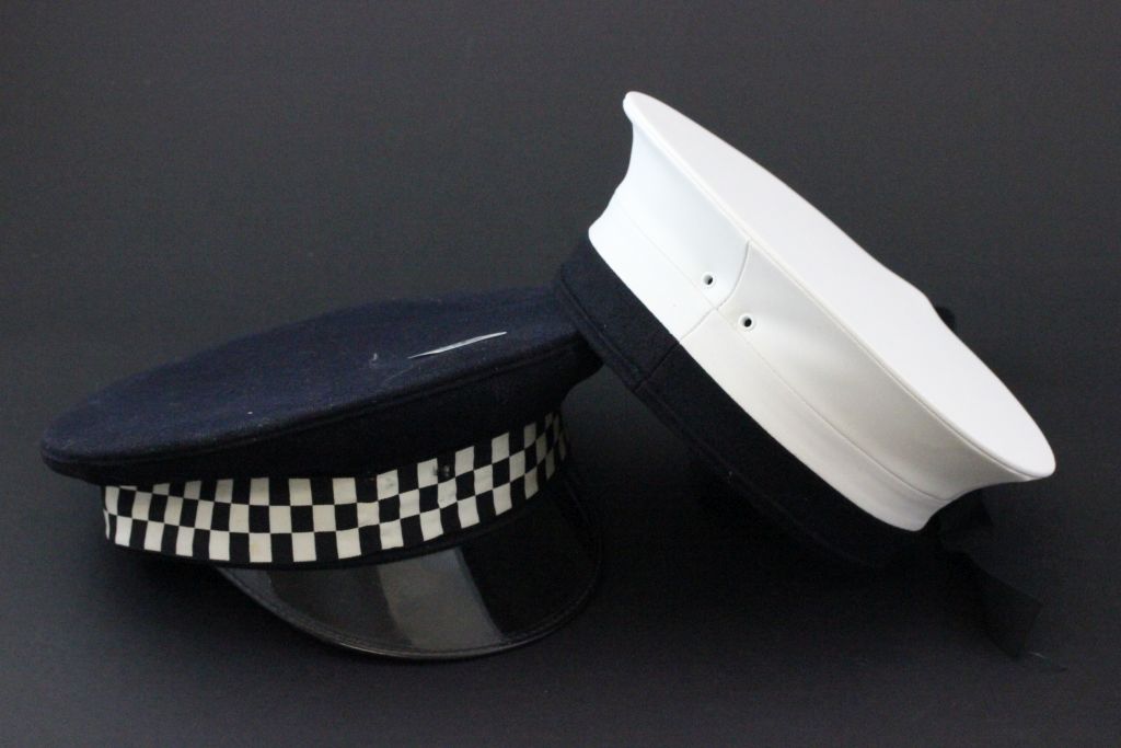 A vintage police hat, along with a sailors hat