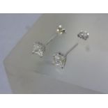 A pair of silver and CZ stud earrings