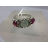 A silver five stone ring set with CZ's and central opal