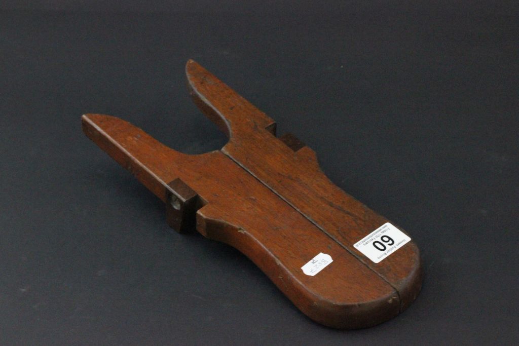 A mahogany folding boot jack