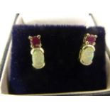 A pair of silver opal and garnet earrings